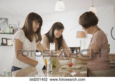 Grandmother, mother and daughter preparing food View Large Photo Image Stock Image - Grandmother, mother and daughter preparing food. Fotosearch