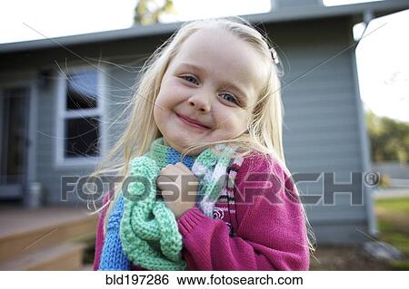 Stock Photograph - Grinning Caucasian girl wearing scarf. Fotosearch