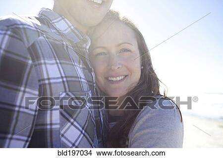 Happy couple hugging outdoors View Large Photo Image Picture - Happy couple hugging outdoors. Fotosearch