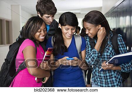 High school students looking at cell phone together View Large Photo Image Stock Photo - High school students looking at cell phone together. Fotosearch