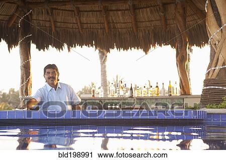 Hispanic bartender working near poolside View Large Photo Image Stock Image - Hispanic bartender working near poolside. Fotosearch