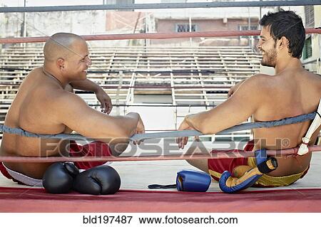 Stock Photo - Hispanic boxers resting after fight. Fotosearch