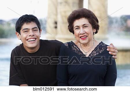 Stock Image - Hispanic boy hugging grandmother. Fotosearch