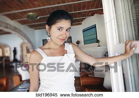 Hispanic bride standing in living room View Large Photo Image Stock Photography - Hispanic bride standing in living room. Fotosearch