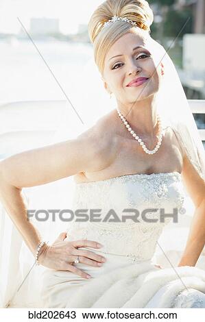 Stock Image - Hispanic bride with hands on hips. Fotosearch