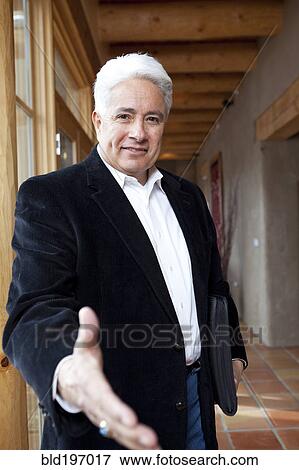 Stock Photo - Hispanic businessman holding out hand. Fotosearch
