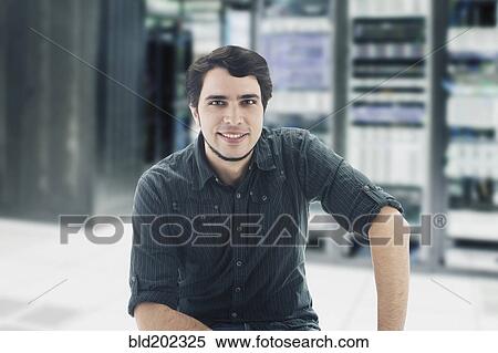 Stock Photography - Hispanic businessman in server room. Fotosearch