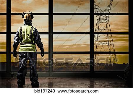 Hispanic construction worker looking out window at power lines View Large Photo Image Stock Image - Hispanic construction worker looking out window at power lines. Fotosearch