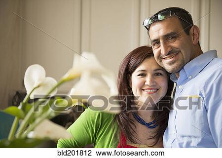 Stock Image - Hispanic couple hugging. Fotosearch