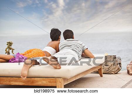 Hispanic couple relaxing near ocean View Large Photo Image Stock Photography - Hispanic couple relaxing near ocean. Fotosearch