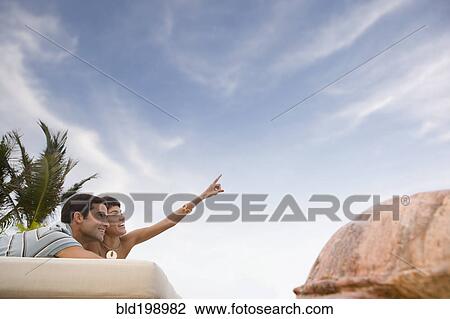 Hispanic couple relaxing outdoors View Large Photo Image Stock Image - Hispanic couple relaxing outdoors. Fotosearch