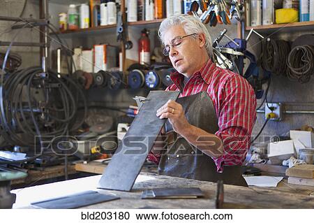 Hispanic craftsman working in shop View Large Photo Image Stock Image - Hispanic craftsman working in shop. Fotosearch