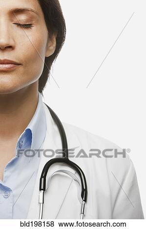 Hispanic doctor with eyes closed View Large Photo Image Stock Photo - Hispanic doctor with eyes closed. Fotosearch