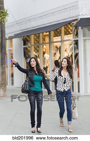Hispanic friends hailing a taxi View Large Photo Image Stock Photograph - Hispanic friends hailing a taxi. Fotosearch
