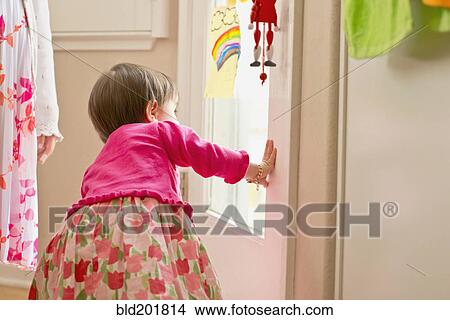 Hispanic girl looking out door View Large Photo Image Picture - Hispanic girl looking out door. Fotosearch