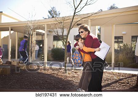 Stock Image - Hispanic grandmother hugging grandson. Fotosearch