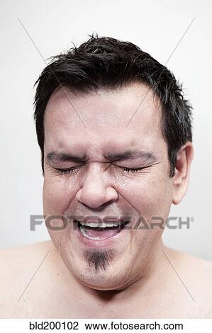 Stock Image - Hispanic man crying. Fotosearch