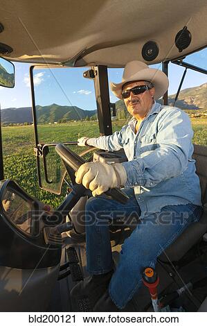 Hispanic man driving tractor View Large Photo Image Stock Image - Hispanic man driving tractor. Fotosearch