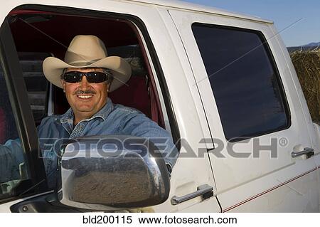 Stock Photography - Hispanic man driving truck. Fotosearch