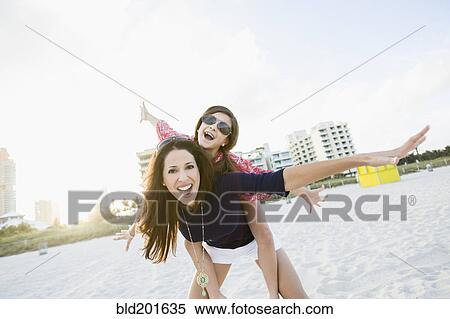Hispanic mother and daughter playing on beach View Large Photo Image Stock Photography - Hispanic mother and daughter playing on beach. Fotosearch