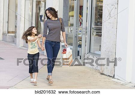 Hispanic mother and daughter shopping together View Large Photo Image Stock Image - Hispanic mother and daughter shopping together. Fotosearch