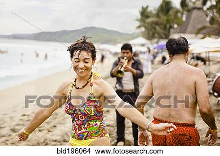 Picture - Hispanic people enjoying music on beach. Fotosearch