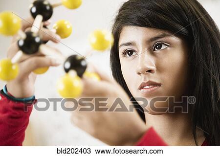 Hispanic student looking at chemistry model View Large Photo Image Stock Image - Hispanic student looking at chemistry model. Fotosearch