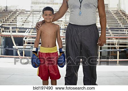 Hispanic trainer standing with boy in boxing gear View Large Photo Image Stock Image - Hispanic trainer standing with boy in boxing gear. Fotosearch