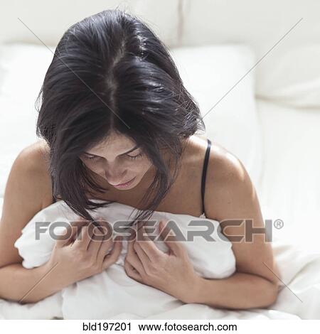 Hispanic woman in bed looking down View Large Photo Image Stock Image - Hispanic woman in bed looking down. Fotosearch