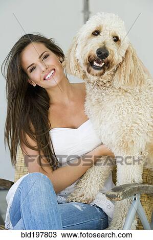Hispanic woman sitting with dog View Large Photo Image Stock Image - Hispanic woman sitting with dog. Fotosearch