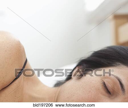 Stock Photograph - Hispanic woman sleeping in bed. Fotosearch
