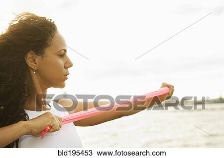 Hispanic woman stretching with resistance band View Large Photo Image Stock Image - Hispanic woman stretching with resistance band. Fotosearch