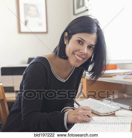 Hispanic woman working in home office View Large Photo Image Stock Image - Hispanic woman working in home office. Fotosearch