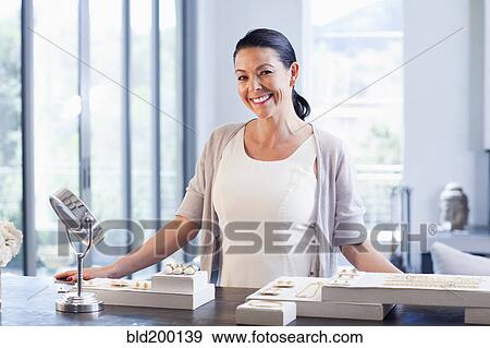 Hispanic woman working in jewelry store View Large Photo Image Stock Photo - Hispanic woman working in jewelry store. Fotosearch