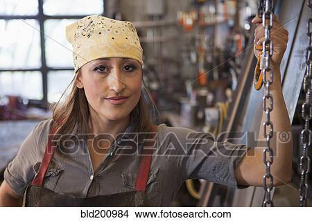 Picture - Hispanic worker in factory. Fotosearch