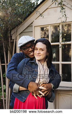 Stock Photo - Husband hugging pregnant wife. Fotosearch