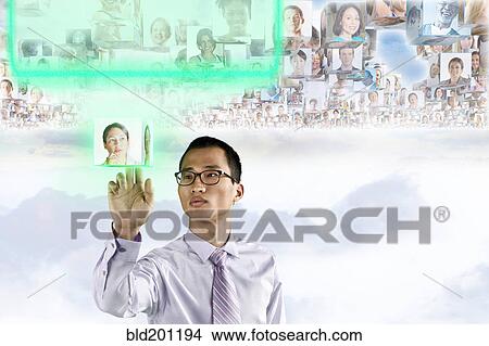 Picture - Images of business people floating above Korean businessman's head. Fotosearch