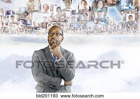 Stock Image - Images of business people floating above African American businessman's head. Fotosearch