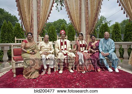 Stock Photo - Indian bride and groom with family in traditional clothing. Fotosearch