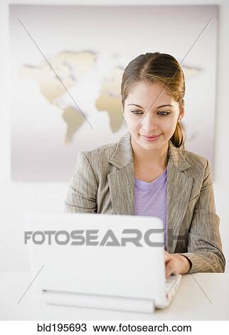 Indian businesswoman using laptop in office View Large Photo Image Stock Image - Indian businesswoman using laptop in office. Fotosearch