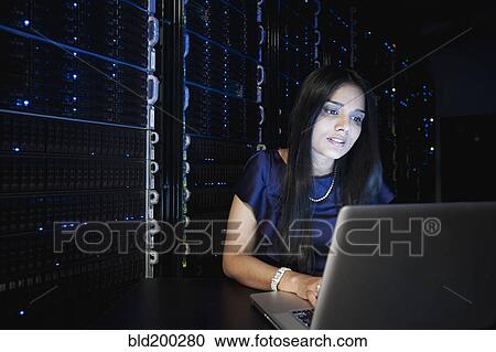 Indian businesswoman working in server room View Large Photo Image Stock Image - Indian businesswoman working in server room. Fotosearch