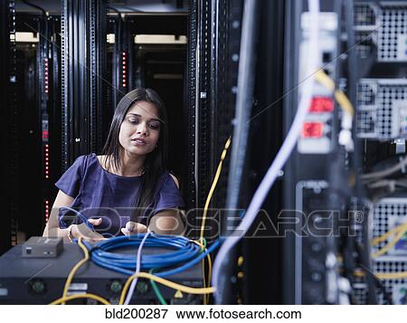 Indian businesswoman working in server room View Large Photo Image Stock Photo - Indian businesswoman working in server room. Fotosearch