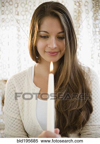 Indian woman looking at candle flame View Large Photo Image Stock Photography - Indian woman looking at candle flame. Fotosearch