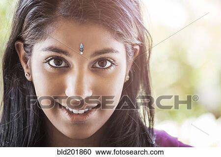 Stock Image - Indian woman with jewel on forehead. Fotosearch