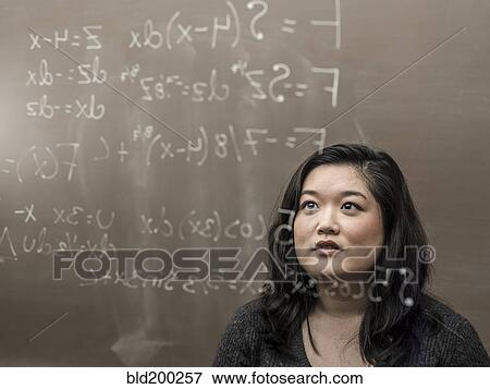 Korean student looking at formula on glass wall View Large Photo Image Stock Photo - Korean student looking at formula on glass wall. Fotosearch