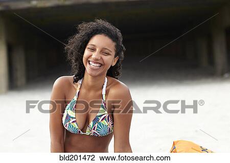 Laughing mixed race woman on beach View Large Photo Image Stock Image - Laughing mixed race woman on beach. Fotosearch