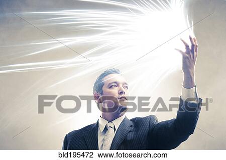 Light radiating from Japanese businessman's hands View Large Photo Image Stock Image - Light radiating from Japanese businessman's hands. Fotosearch