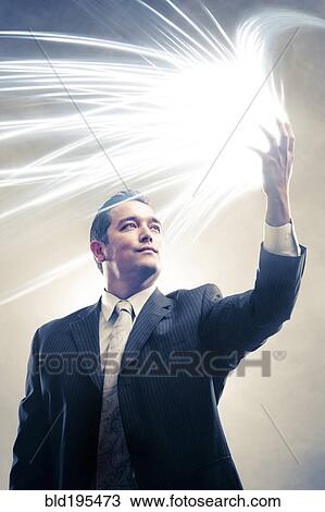 Light radiating from Japanese businessman's hands View Large Photo Image Stock Image - Light radiating from Japanese businessman's hands. Fotosearch