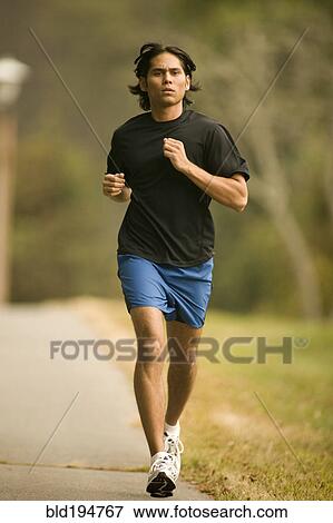 Man jogging on sidewalk View Large Photo Image Stock Photo - Man jogging on sidewalk. Fotosearch