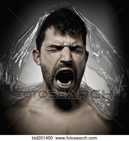 Stock Image - Man shouting with plastic on his head. Fotosearch